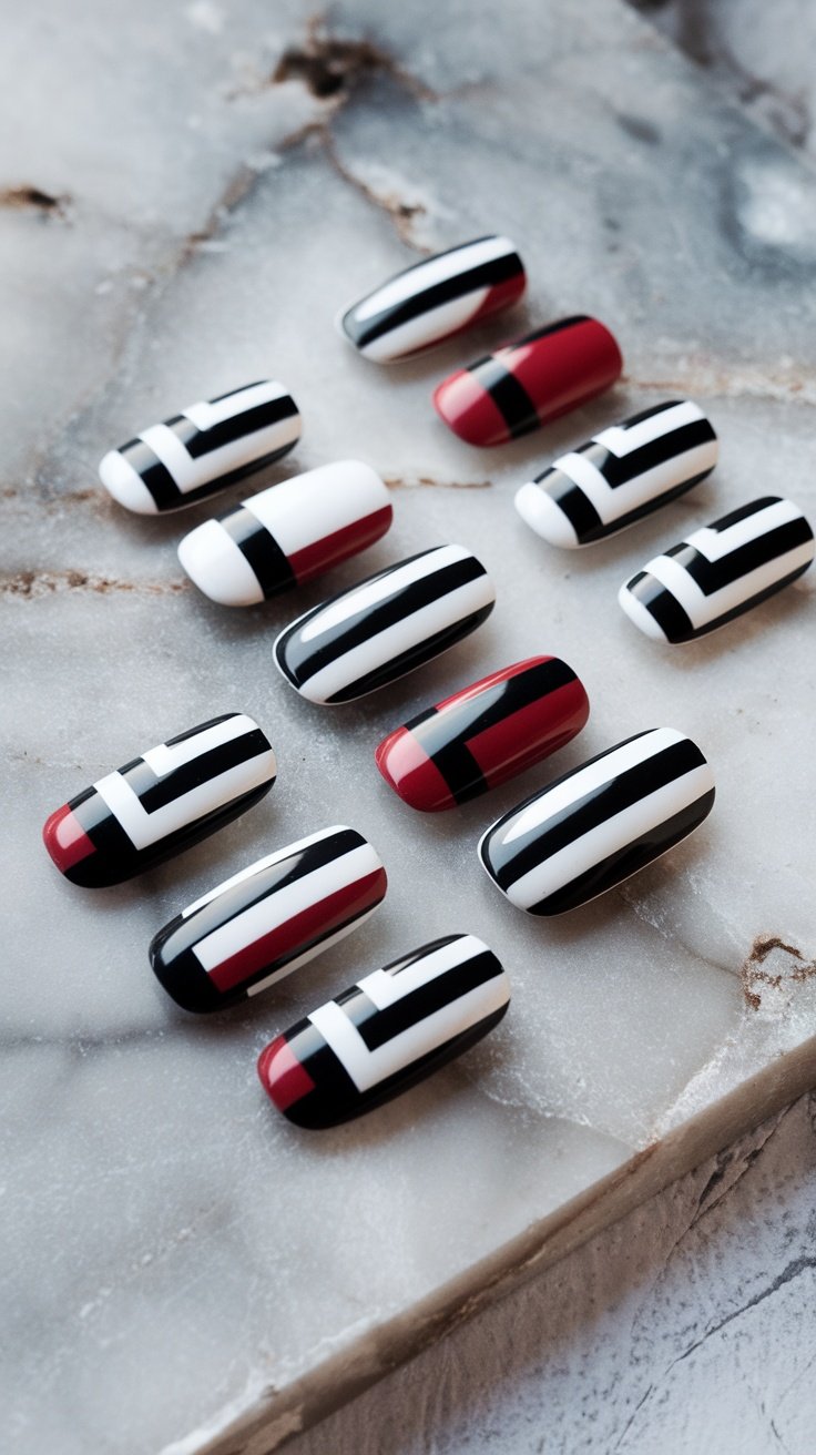 Nails featuring geometric patterns with black, white, and red colors.