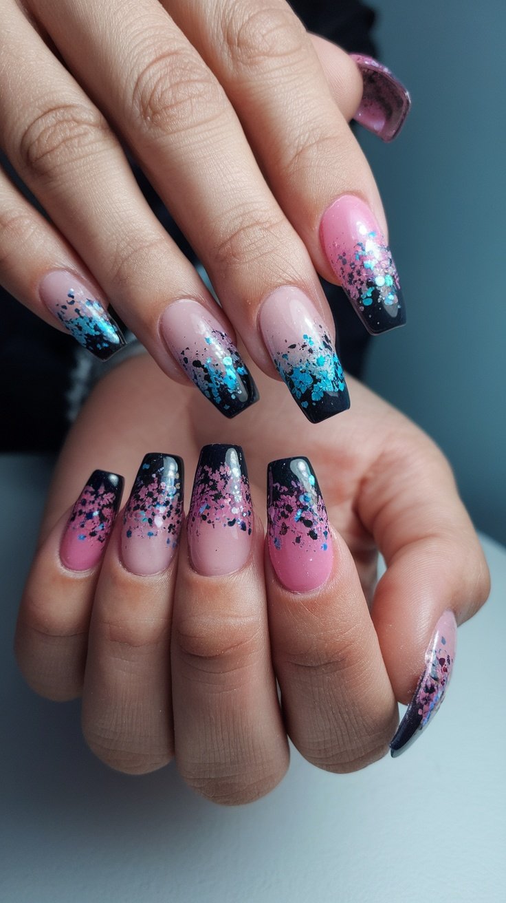 Close-up of hands with gradient glitter nails featuring pink and purple shades.