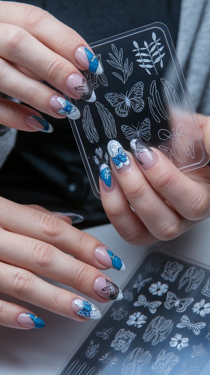 A close-up of hands with colorful nail designs featuring floral and butterfly patterns, holding a nail stamping plate.